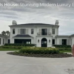 The beautiful exterior of the sprawling Anthony Edwards House, featuring modern-classic design, white stucco, and a circular driveway.