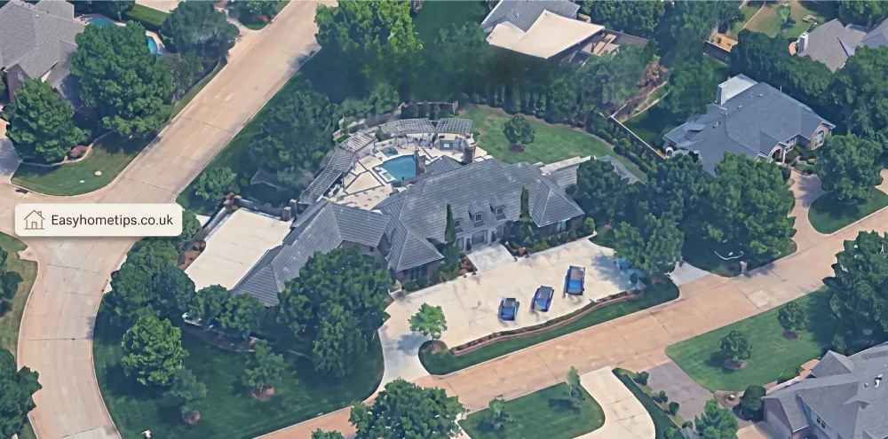House overview of a sleek modern luxury residence featuring clean architectural lines, expansive glass walls, and a dramatic two-story exterior with elegant landscaping and infinity pool views.