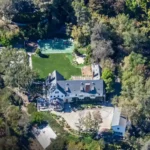 Exterior view of the Sandra Bullock house showing the wooded Beverly Hills estate